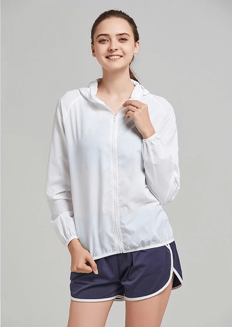 Woman wearing a white waterproof polyester jacket and navy shorts, perfect for hiking and outdoor activities, showcasing the SF2005 model.